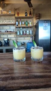 two cocktails sitting on a counter in a kitchen at Villa Macarena Apartamentos Boutique - Only Adults in Puerto Escondido +21 photos