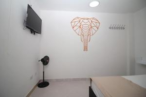 a wall with a drawing of an elephant on it at DAM Hotel Pereira in Pereira +67 photos