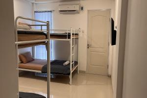 a room with two bunk beds and a door at Bluebell House in Labuan Bajo