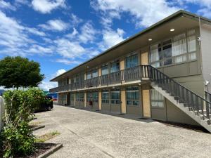 a large building with a staircase on the side at Rotorua Stay in Rotorua