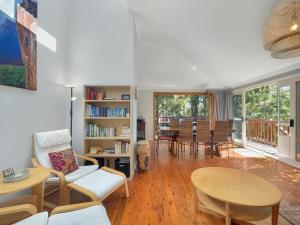a living room with a table and chairs at Riverside 3-Bed Townhouse with Spacious Deck & BBQ in Mossy Point