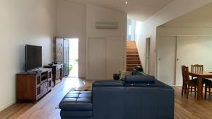 a living room with a couch and a table at Hook Wine Sinker in Brunswick Heads
