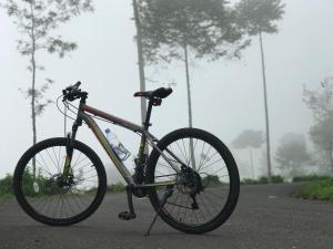 a bike parked on the side of a road at Moza House Wonosobo in Wonosobo