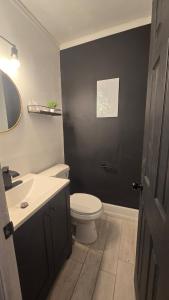 a bathroom with a white toilet and a sink at Luxury 4 Bedroom Modern Escape in Detroit