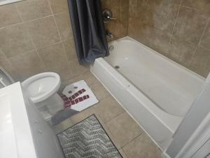 a bathroom with a toilet and a tub and a sink at Entire 3 bedrooms Apt,10sleepers ,15 mins to NYC in Jersey City