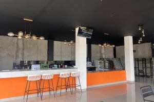 a bar with stools in a room with a counter at Bluebell House in Labuan Bajo
