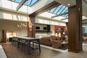 a lobby with a table and chairs and a couch at Durham Marriott City Center in Durham