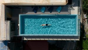 a man swimming in a swimming pool at P-Park Hotel Pattaya in Pattaya North