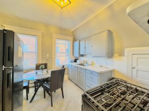 a kitchen with a table and a stove top oven at Waterfront NYC skyline views in Union City