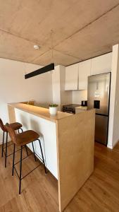 a kitchen with a counter with two chairs and a counter top at Brand New! Urban Bliss Stay - Luxe Living in Montevideo