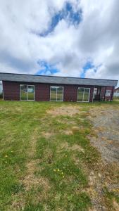 ein Gebäude mit einem Grasfeld davor in der Unterkunft Cabaña kiro in Dalcahue