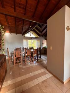 a dining room with a table and chairs at CHALET GRANDE en VALERIA DEL MAR y PLAYA in Valeria del Mar