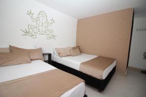 Voodi või voodid majutusasutuse DAM Hotel Pereira toas