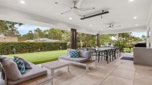 an open patio with a table and chairs at Alkira at The Vintage in Pokolbin