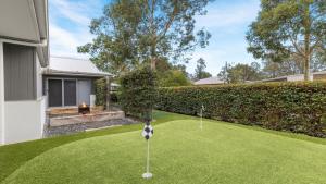 a golf course in the backyard of a house at Alkira at The Vintage in Pokolbin +9 photos
