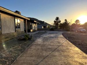 an empty driveway in front of a house at Lux Private Home - Pool, Billiards, 8 Smart TVs, Board Games, Cotton Bedding - The Stone Sanctuary at McCullough Hills Trailhead in Las Vegas