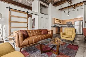 a living room with a couch and two chairs and a table at Luxury Industrial 2 Bedroom 2 Full Bath Strip District & Riverwalk in Pittsburgh