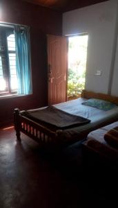 Postel nebo postele na pokoji v ubytování Athena Homestay