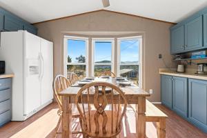 a kitchen with a table with chairs and a refrigerator at Mountain Farm Stay, Alpacas and Views, Royal Gorge 15min in Canon City