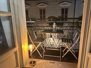 a view of a balcony with a table and chairs at Cuore al centro - luxury apt near Egyptian Museum with parking by Home a porter in Turin