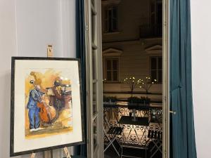 a painting of a man standing outside a door at Cuore al centro - luxury apt near Egyptian Museum with parking by Home a porter in Turin