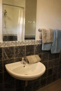 a bathroom with a sink and a mirror at Maison A La Mer in Retranchement +32 photos