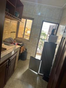 una cocina con fregadero y frigorífico en BaRaN HOME, en Yaoundé