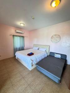 Un ou plusieurs lits dans un hébergement de l'établissement Saipan Angel Villa