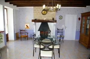 a dining room with a glass table and chairs at Gîte Chez Jo in Longchamp-sur-Aujon +29 photos
