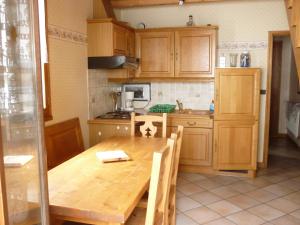 a kitchen with wooden cabinets and a wooden table at Chalet Analma in Planay