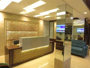 a lobby with a chair and a glass wall at Geetanjali International in Deoghar