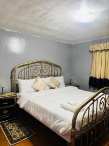 a bed with white sheets and pillows in a bedroom at The Regal Sanctuary in Niagara Falls +5 photos