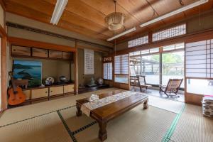 a living room with a table and a guitar at 音毬 - Otomari - in Miyazu
