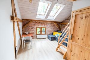 a room with a staircase and a brick wall at Wozownia Nad Bobrem in Wleń