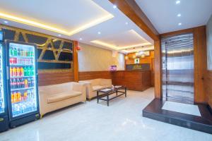 a living room with a drink vending machine and a couch at Treebo Anam International in Mumbai