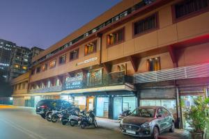 a row of motorcycles parked in front of a building at Treebo Anam International in Mumbai