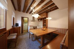 a kitchen and dining room with a wooden table at Ca' Ermina & Garden in Venice