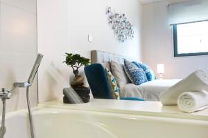 a bathroom with a bath tub and a couch at Oriente Marina Housing by APT IIN in Lisbon