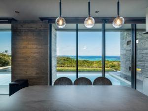 a large table in a room with a view of the ocean at Iluvio Resort Motobu in Motobu