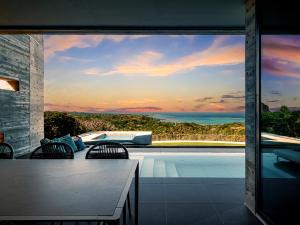 a house with a view of a swimming pool at Iluvio Resort Motobu in Motobu