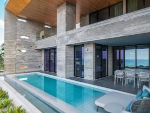 an image of a house with a swimming pool at Iluvio Resort Motobu in Motobu