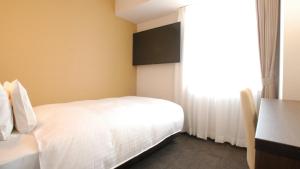 A bed or beds in a room at AB Hotel Kakamigahara