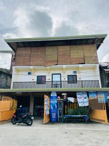a building with a motorcycle parked in front of it at Cris&Mar Homestay Extension in Burgos