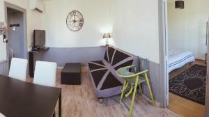 a room with a bed and a table and chairs at S-e-r-a-l-y 2 in Égliseneuve-dʼEntraigues +24 photos