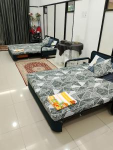 a room with a bed and a couch in it at WHG Homestay, Paya Berenjut Kemaman in Cukai