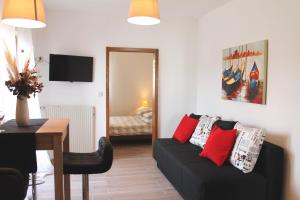 a living room with a couch and a table at Apartments Lukas in Medulin
