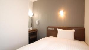 A bed or beds in a room at AB Hotel Kakamigahara