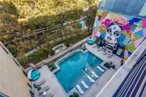 an overhead view of a pool with a mural on a building at San Antonio TX Condo on Riverwalk w King Ste,Pets in San Antonio