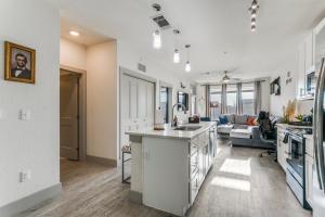 a kitchen and living room with a sink and a couch at San Antonio TX Condo on Riverwalk w King Ste,Pets in San Antonio