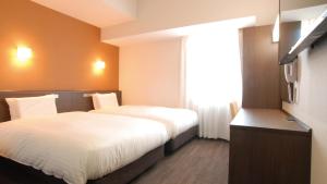 A bed or beds in a room at AB Hotel Kakamigahara